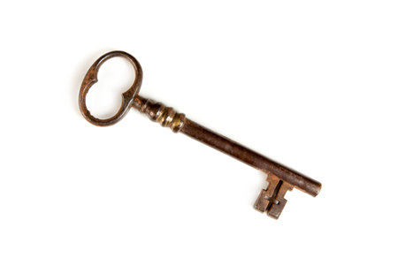 Large iron old-fashioned key isolated on whiteの写真素材