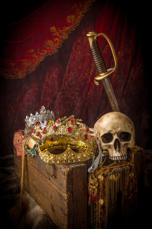 Romantic image of a treasure chest filled with jewellery, precious gems and golden king's crownsの写真素材