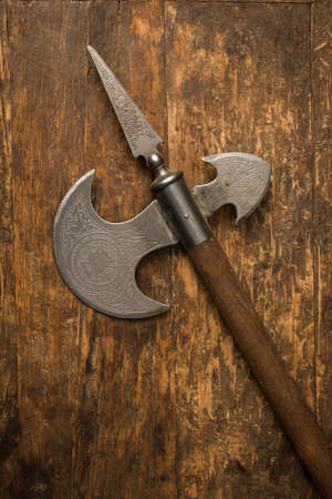 Medieval battle axe with wooden handle and steel blade with Spanish engravingsの写真素材