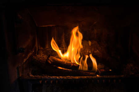 Closeup of fire burning in an old fireplace, can be used to composite in an existing image with unused fireplaceの写真素材