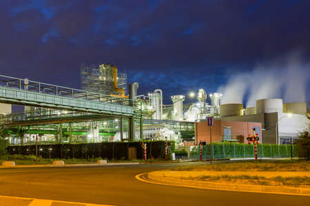 Night time view on illuminated heavy industry in the port of Antwerp in Belgiumの写真素材