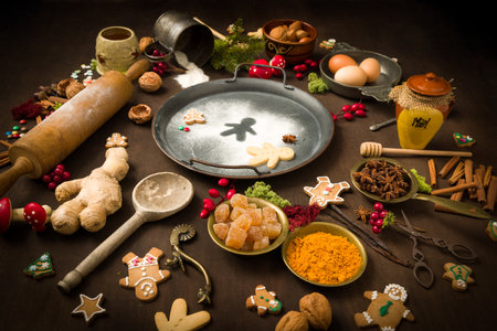 Vintage still life of Christmas gingerbread cookies and their ingredients arranged in a colourful circleの写真素材