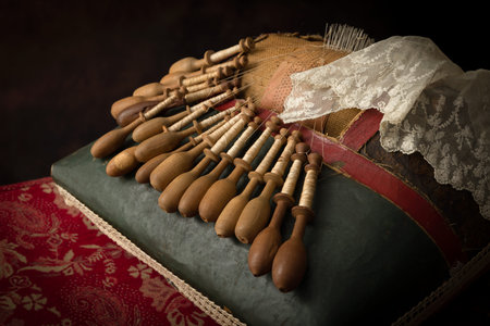 Antique Flemish lace making pillow with very old wooden bobbinsの写真素材