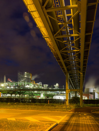Night time view on illuminated heavy industry in the port of Antwerp in Belgiumの写真素材