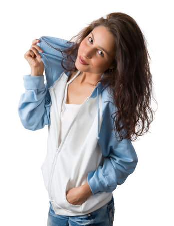 Confident young woman with natural charm posing against a white backgroundの写真素材