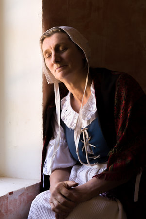 Vermeer or Rembrandt style portrait of a woman sitting at her windowの写真素材