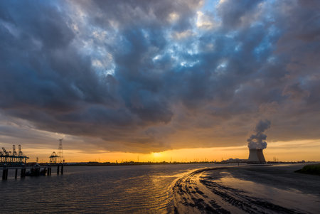 Colorful sunset over Antwerp world port in Belgium, with a view on the towers of the nuclear plantの写真素材