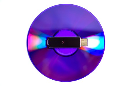 Shiny data storage for tasty content: DVD and flash USB drive isolatedの写真素材