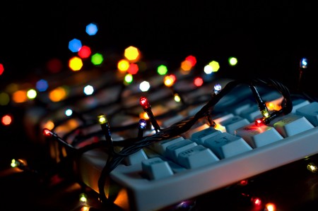 Say no to work on holidays: computer keyboard corded with electric color garland lightsの写真素材