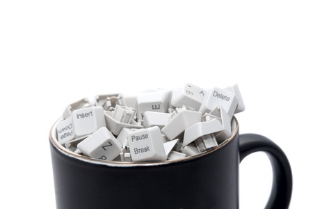 No rest on office work: keyboard keys in coffee mugの写真素材