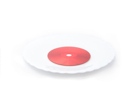 Taste digital content: a red compact disc on isolated white plate (dish)