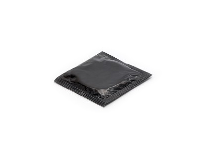 Simple black condom isolated on white backgroundの写真素材