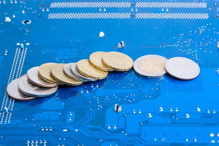 Electronic money: dollar and euro coins over technological backgroundの写真素材