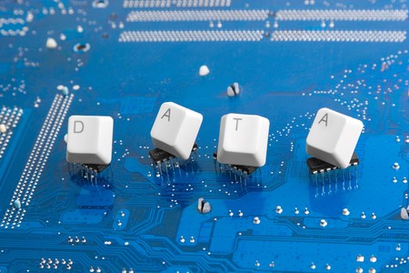 Data transfer concept: microchip with keyboard keys DATA caption on blueの写真素材