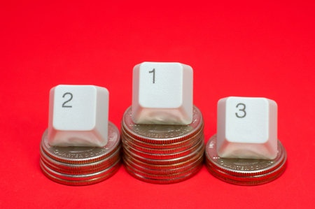 Financial championship: coins pedestal and keyboard numbers as winners