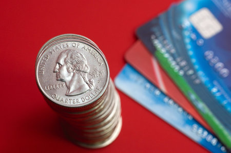 Get rich: dollar coin stack and credit cards on red