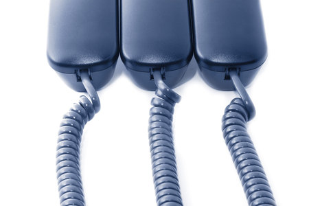 Call center working: three phone handset with cords