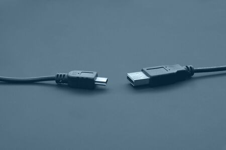USB and miniUSB cords isolated on blackの写真素材