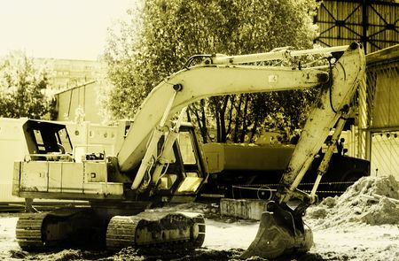 Excavator on project site, toned imageの写真素材
