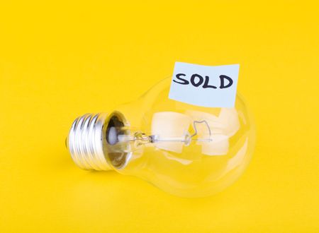 Idea sold: business concept made by light bulb and captionの写真素材