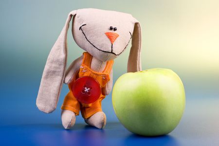 Mmmm... healthy food! Concept with hare toy and appleの写真素材