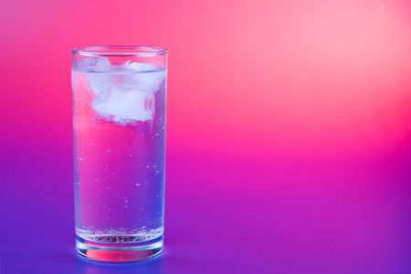 Ice cold cocktail - glass with drink on color backgroundの写真素材