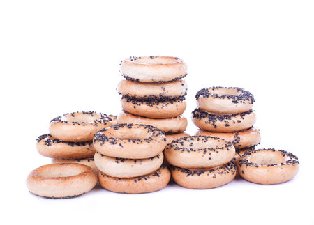 Bread rings with poppyseed stacks isolated on whiteの写真素材