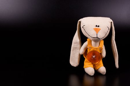 Funny hare toy on black background with copyspaceの写真素材