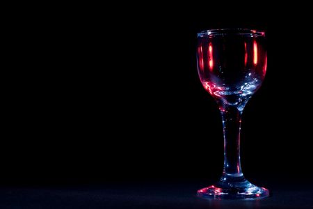 Color glares on wine glass in the darkの写真素材