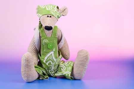 Sad sitting toy with rucksack on color backgroundの写真素材