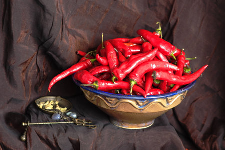 chili peppers in the ceramic dish on the counter of the ancient oriental store (imitation)の写真素材