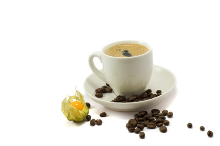 Cup of coffe and physalis on the whiteの写真素材
