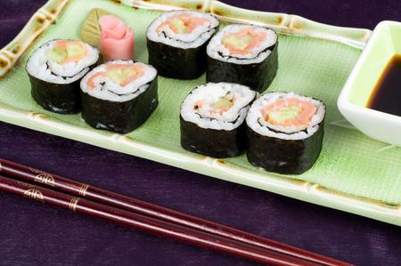 A selection of rolls sushi against a magenta backgroundの写真素材