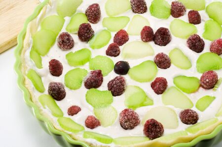 Shot of rhubarb pie with berryes on the tableの写真素材