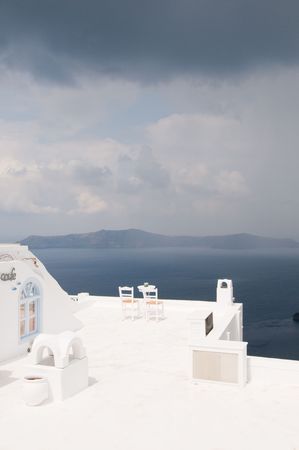 Two chairs on Santorini island, beautiful view, romanticの写真素材