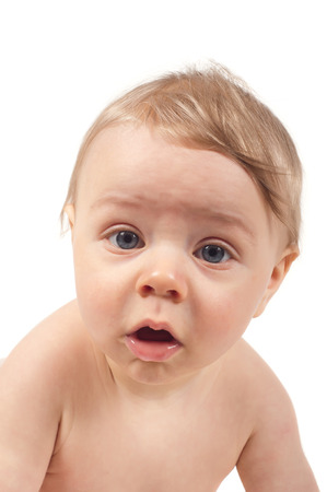 Serious baby watching in camera, isolated on whiteの写真素材