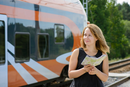 Girl holding map and watching on a train