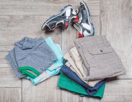Photography of boy's casual outfits. Boy's casual outfits on wooden backgroundの写真素材