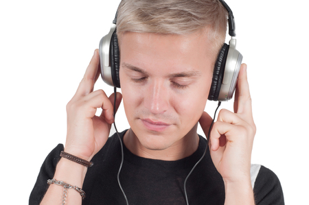Man in headphones listening music isolated on whiteの写真素材