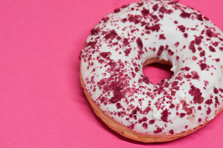 Macro shoot of white donut over pink background