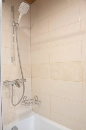 Fragment with shower of a luxury modern bathroom in apartment