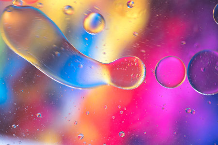 Oil drops in water. Abstract psychedelic pattern image rainbow colored. Abstract background with...