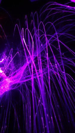 Overlaying wavy lines forming an abstract pattern on a dark background.