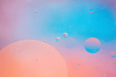 Defocused pastel colored abstract background picture made with oil, water and soapの写真素材
