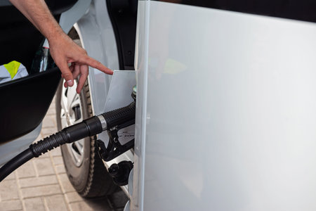 Car refueling on a petrol station with somebody