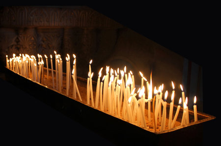 Church, wax candles on a black background