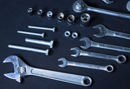 Set of mechanical tools. Wrenches, spanners and nozzles on black backgroundの写真素材