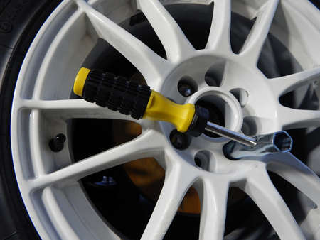 Cross wrench inside wheel at mounting custom car rimの写真素材