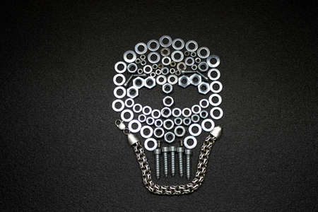 Metal art. Skull made by screw nuts, washers and boltsの写真素材