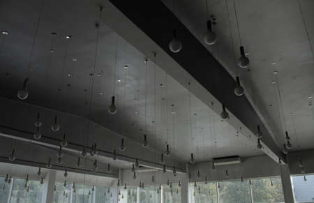 Round ceiling lamps on wires at the lighting storeの写真素材